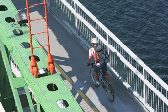 A cyclist crosses the Macdonald Bridge Bicycle Lane