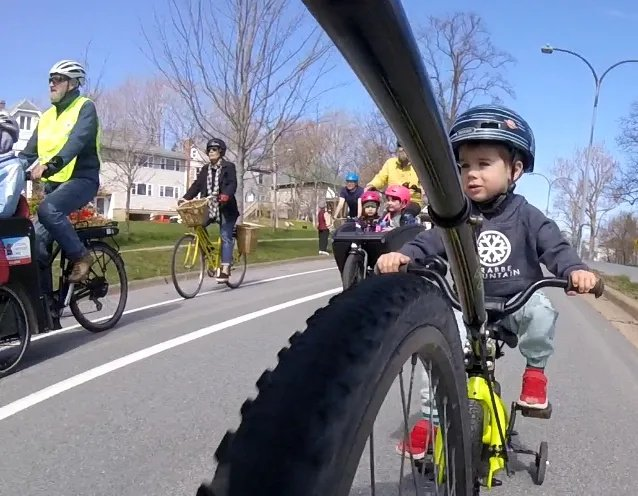 Photo: Elliott MacKinnon takes a ride at Kidical Mass with his Dad, Sean.